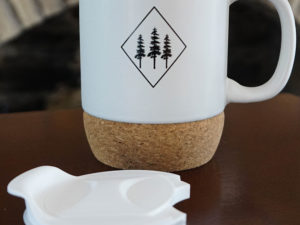 white mug with lid and design