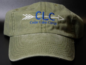 green hat with arrow going through letters